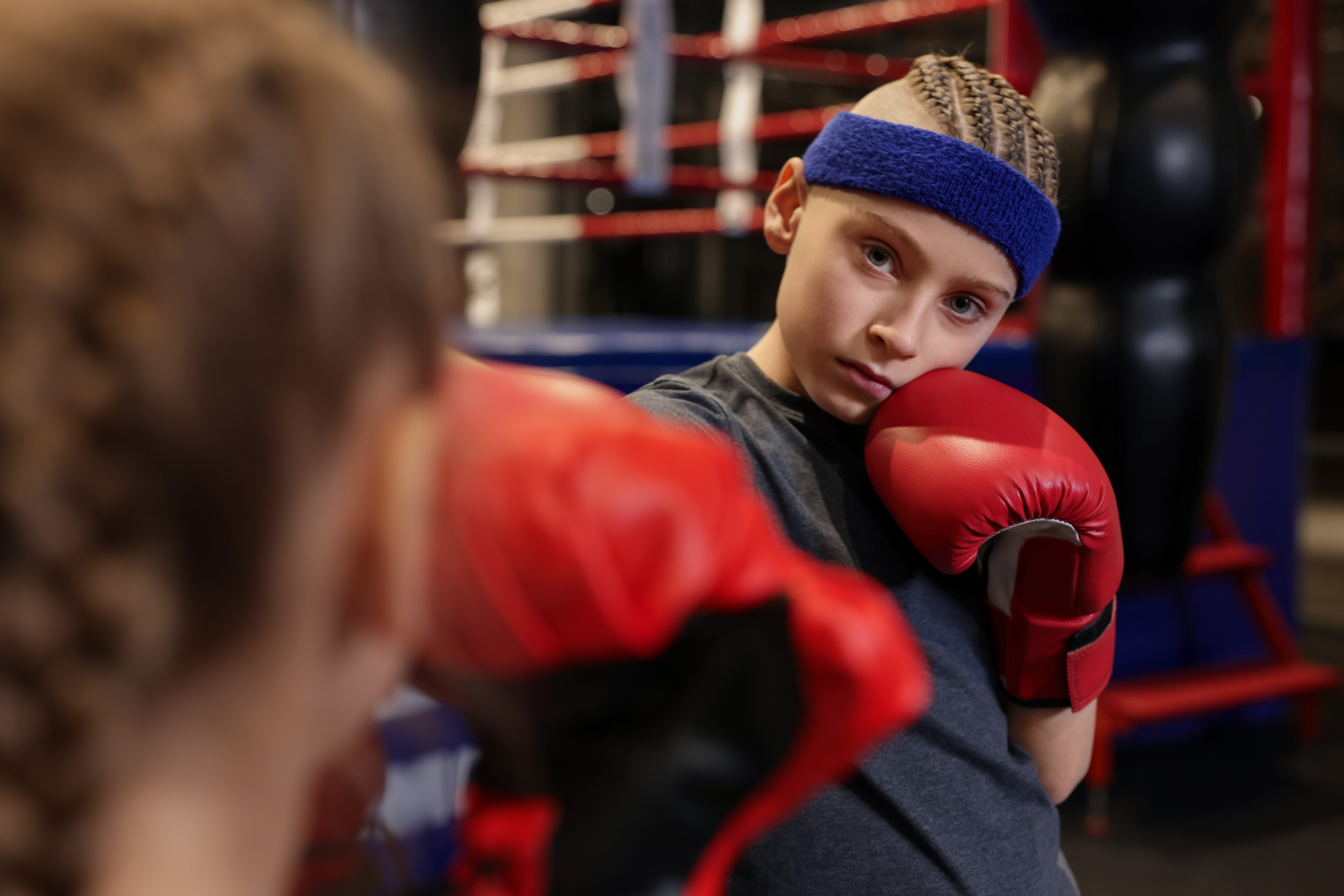 Children having boxing practice in training center